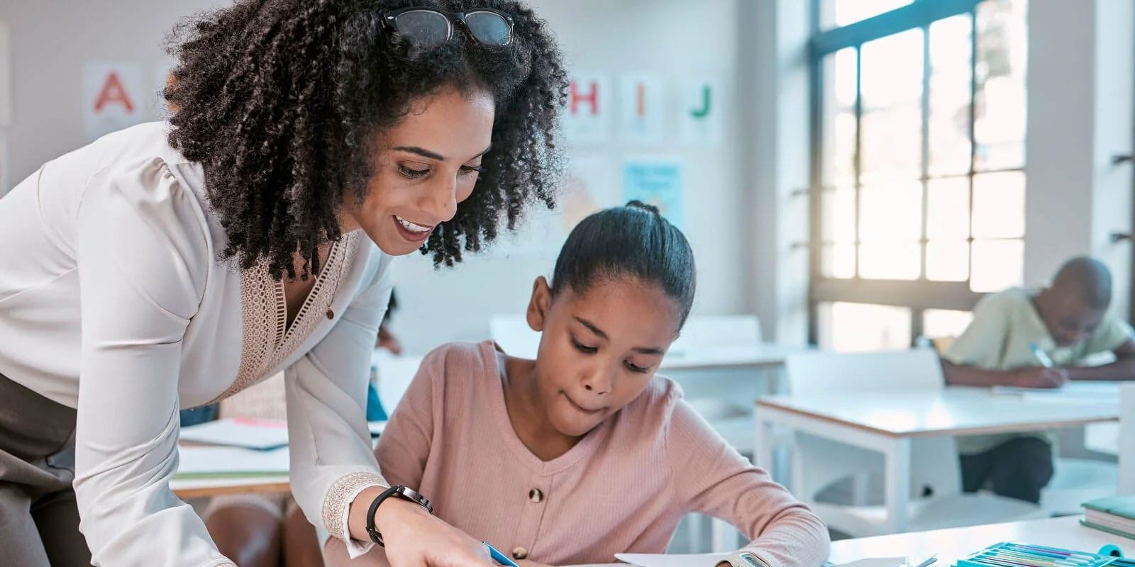 Student working with teacher.