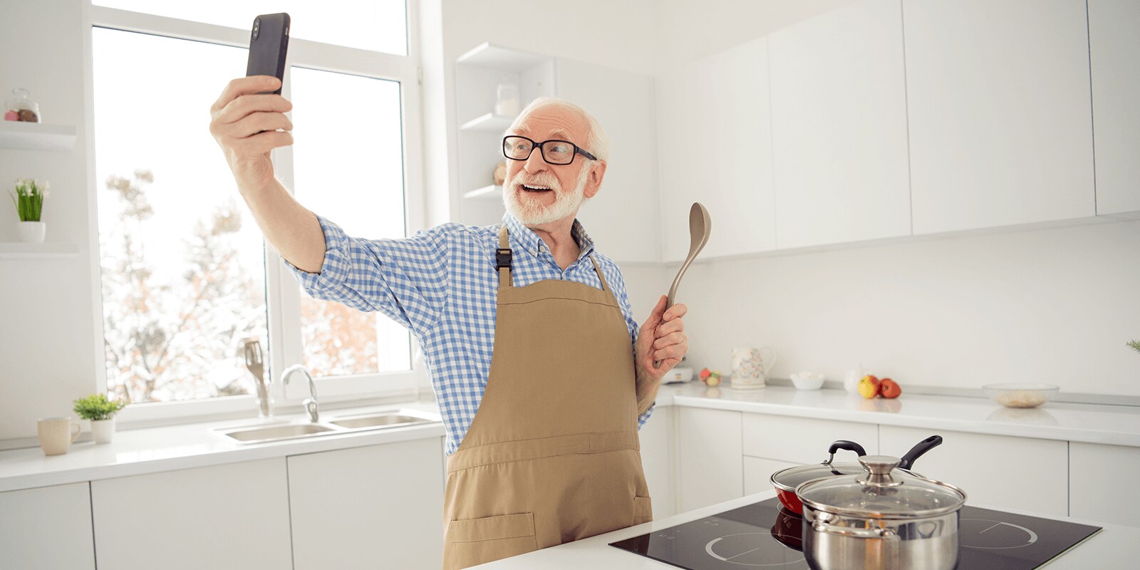 Image of a senior citizen cooking and talking a selfie