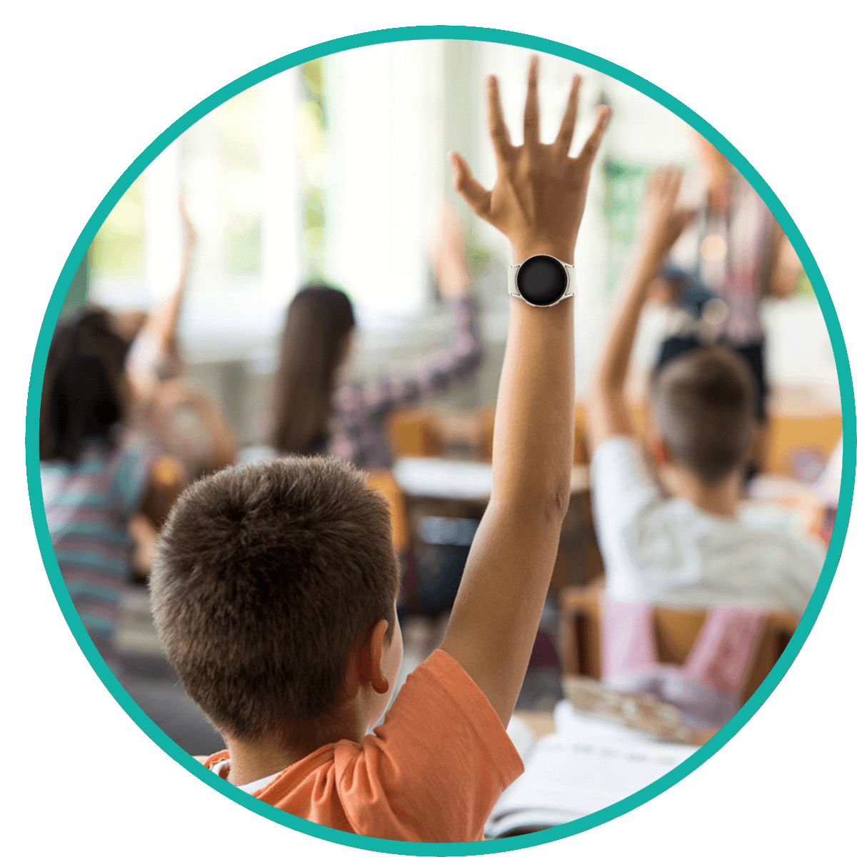 Child raising hand in class wearing a Revibe watch.