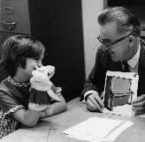 Lloyd Dunn instructing a child with materials from a Peabody Test