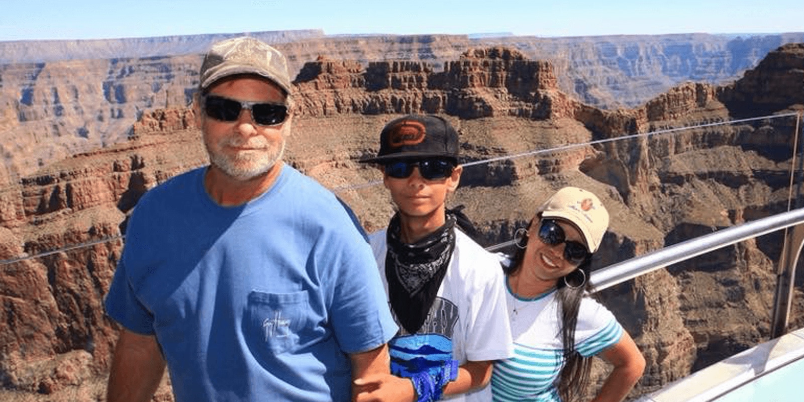 Three people with mountains in background