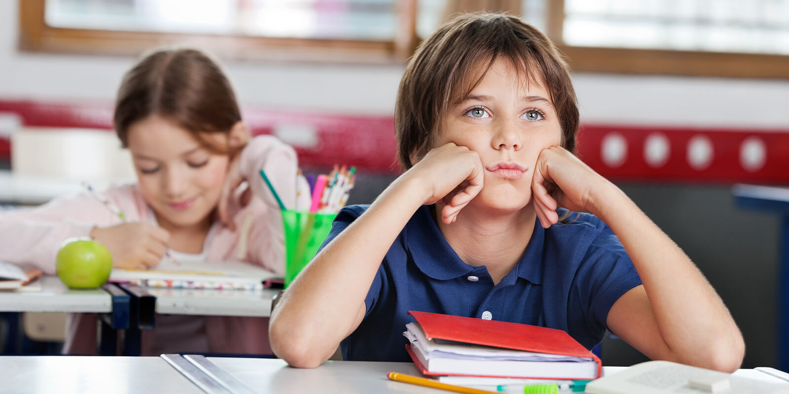 Student in classroom looking bored. 