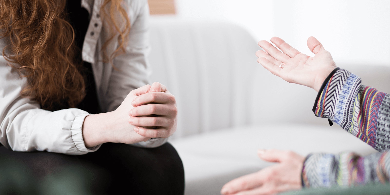 Close up of two sets of hands - a psychologist and patient