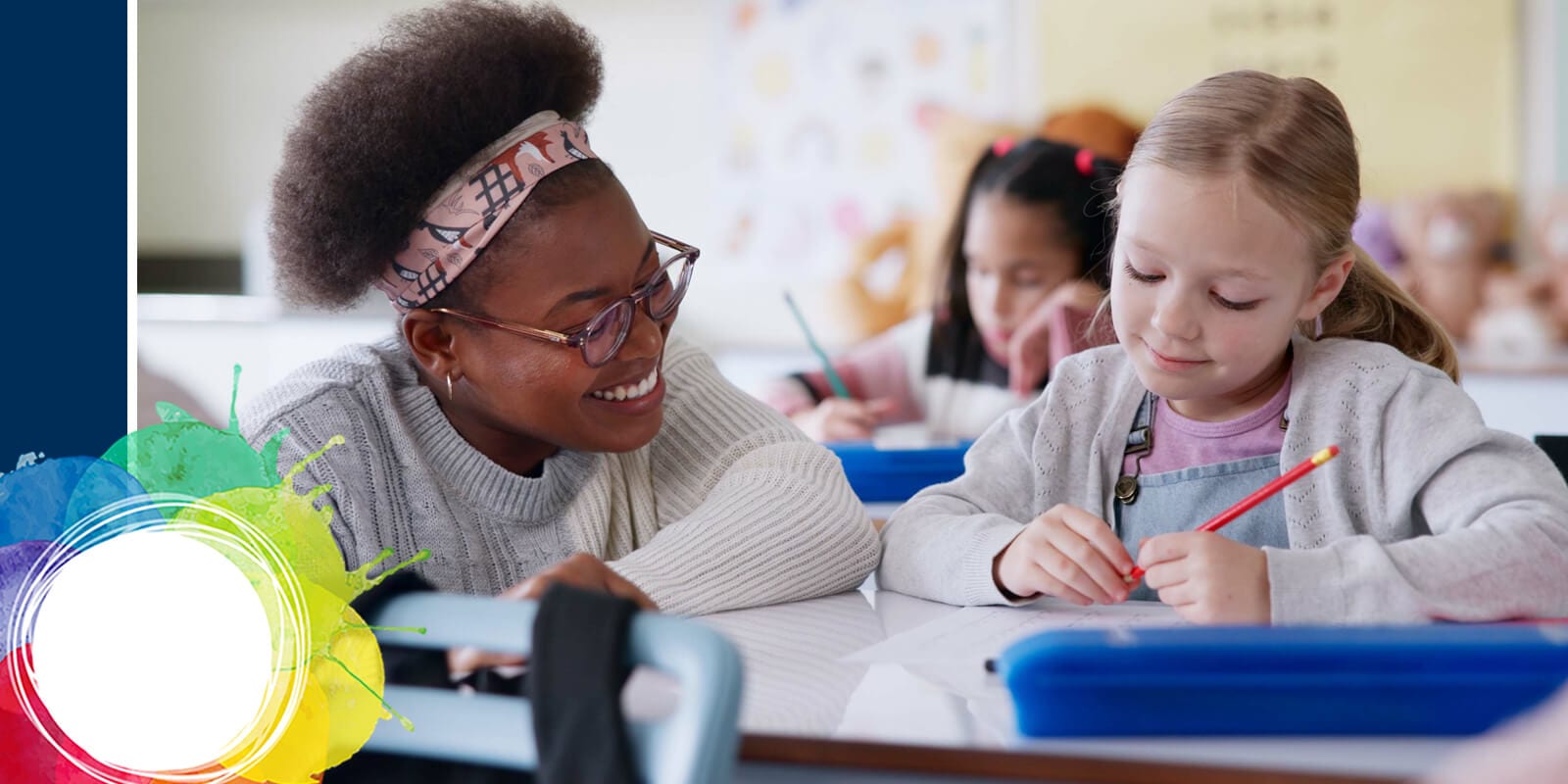 Children in a classroom setting, one with curly hair, sitting at desks with colorful notebooks, engaged in a learning activity.
