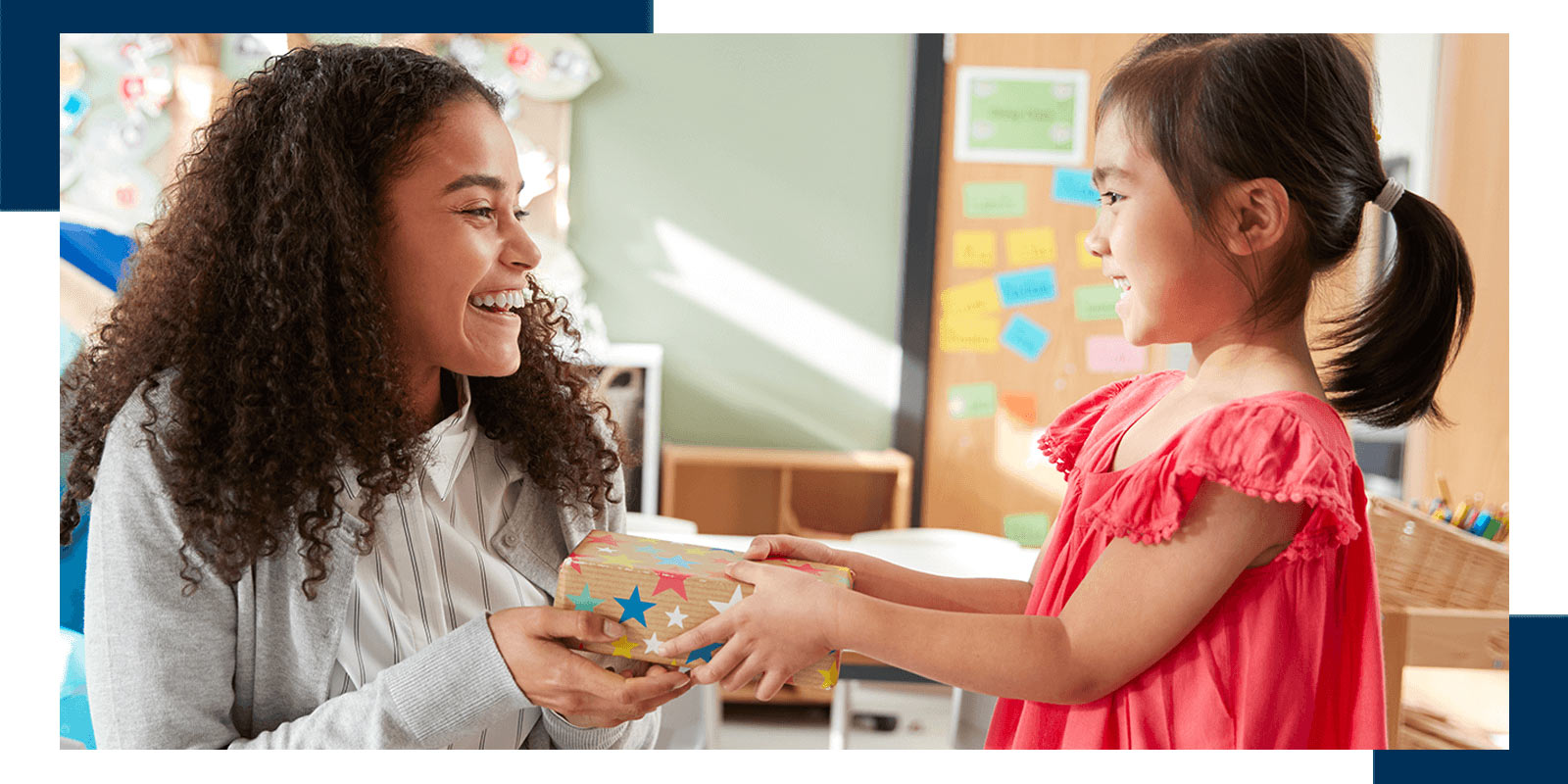 Smiling teacher assisting young student