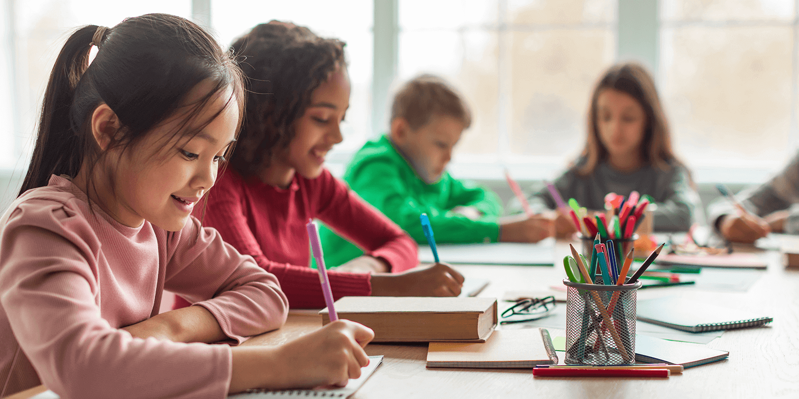 Children in classroom writing