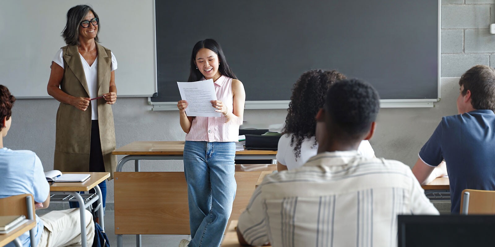 Student reading in front of the classroom