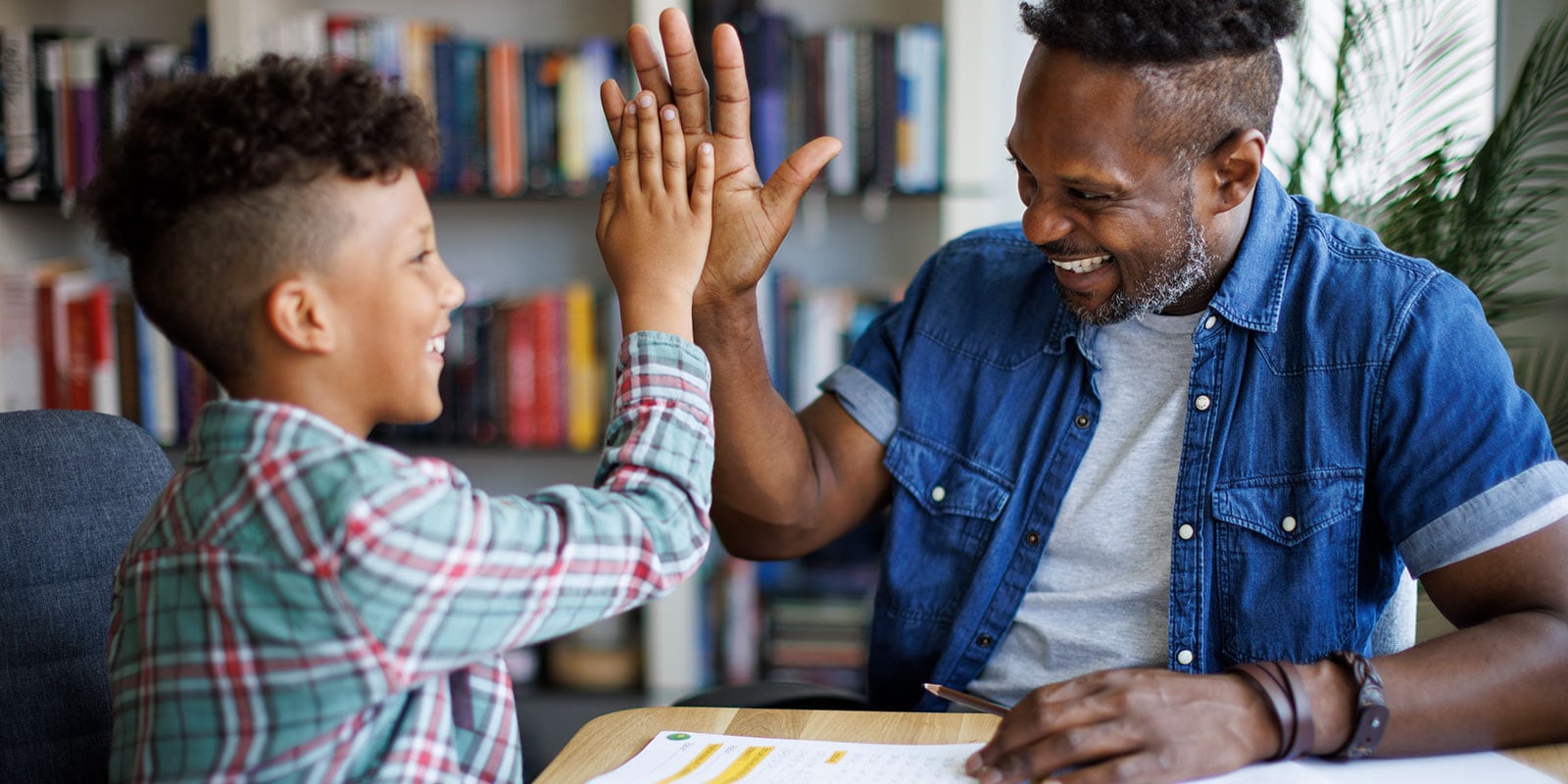 Teacher and student working in a library.